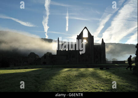 The Autumn sun rises behind Tintern Abbey in the Wye Valley. Stock Photo