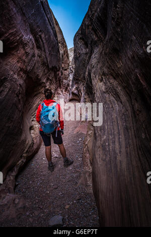 Young Woman Backpacker exploring Little Wild Horse Canyon Stock Photo