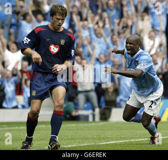 Manchester City's David Sommeil celebrates scoring the equaliser as Portsmouth's Arjan De Zeeuw shows his dejection, during their FA Premiership match at Man City's City of Manchester Stadium. Manchester City drew 1-1 with Portsmouth. Stock Photo
