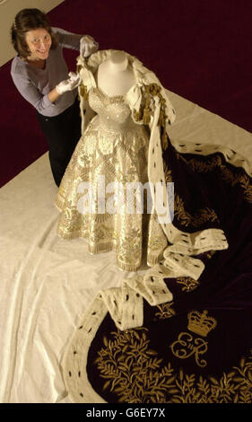 Senior Textile Conservator Jane Wood attends to the Coronation Dress and Robe of Estate in the Ball Supper Room at London's Buckingham Palace. * The dress, which was worn by Britain's Queen Elizabeth II on Coronation Day, will be on show as part of this year's summer opening of the State Rooms. Stock Photo