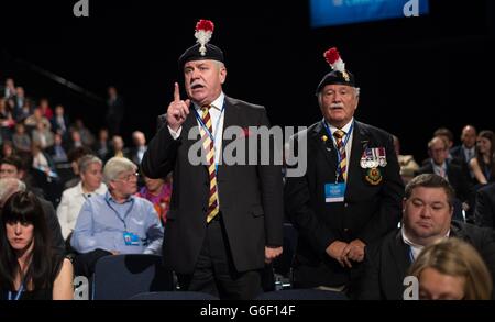 Colonel Ian Brazier (left) and Captain Joe Eastwood of the 2nd Battalion Royal Regiment Fusiliers heckle Defence Secretary Philip Hammond during his speech, due to the disbandment of their regiment, on the first day of the Conservative Party conference at Manchester Central in Manchester. Stock Photo