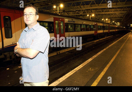 Commuter Ron Edwards, 43, a business development manager at Waterloo Station in central London. Mr Edwards was one of the rail commuters who suffered the journey from hell in sweltering temperatures when it took them an amazing nine hours to travel 70 miles. One hundred passengers, including a pregnant woman and elderly people, were left in baking carriages of a host of trains trying to get to London Waterloo after a series of accidents and delays. The initial hold-up on the line was because a 29-year-old rail worker died after slipping and falling on to a live line at Basingstoke station in Stock Photo