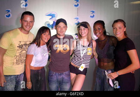 Gemma Pearce, 19, Birmingham, (4th from left) poses with pop group Liberty X (from left) Tony Lundon, Michelle Heaton, Kevin Simm, Kelli Young and Jessica Taylor, during a photocall at Cargo in East London, after winning a competition to appear Liberty X's latest music video 'Jumpin'. Over the past month 3, the new video mobile network and Liberty X, launched a nationwide star search and after thousands of applications 10 lucky winners will star in their new video. Stock Photo