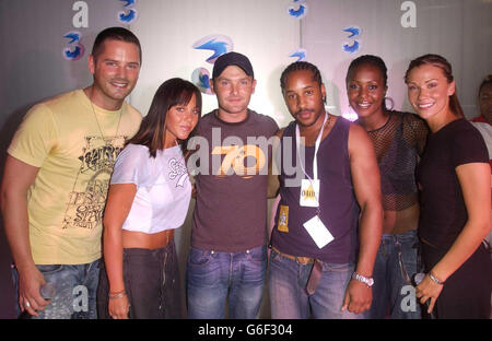 Christopher Syrus, 24, London, (4th from left) poses with pop group Liberty X (from left) Tony Lundon, Michelle Heaton, Kevin Simm, Kelli Young and Jessica Taylor, during a photocall at Cargo in East London, after winning a competition to appear Liberty X's latest music video 'Jumpin'. Over the past month 3, the new video mobile network and Liberty X, launched a nationwide star search and after thousands of applications 10 lucky winners will star in their new video. Stock Photo