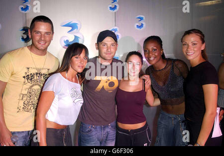 Maggie Smith, 18, Manchester, (4th from left) poses with pop group Liberty X (from left) Tony Lundon, Michelle Heaton, Kevin Simm, Kelli Young and Jessica Taylor, during a photocall at Cargo in East London, after winning a competition to appear Liberty X's latest music video 'Jumpin'. Over the past month 3, the new video mobile network and Liberty X, launched a nationwide star search and after thousands of applications 10 lucky winners will star in their new video. Stock Photo