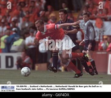 10-JUN-96. Scotland v Netherlands. Netherlands' Ronald de Boer gets the ball away from Scotland's John Collins Stock Photo
