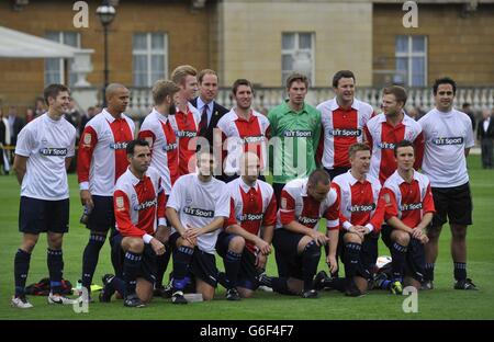 The Duke of Cambridge stands with the Civil Service FC prior to their match against Polytechnic FC, in the grounds of Buckingham Palace's garden, central London. Stock Photo