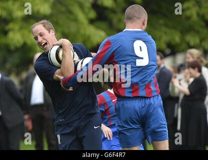 The Duke of Cambridge trains with members of the Royal household, during the second half of a match between the Polytechnic FC and the Civil Service FC, in the grounds of Buckingham Palace's garden, central London. Stock Photo