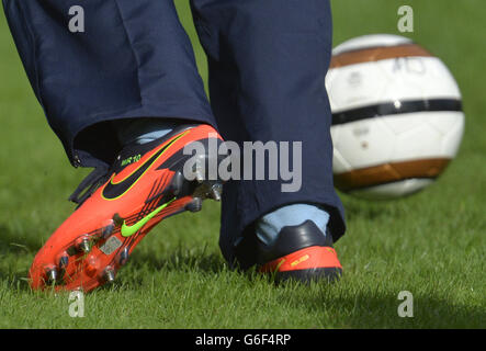 The boots of the Duke of Cambridge, as he trains with members of the Royal household, during the second half of a match between the Polytechnic FC and the Civil Service FC, in the grounds of Buckingham Palace's garden, central London. Stock Photo