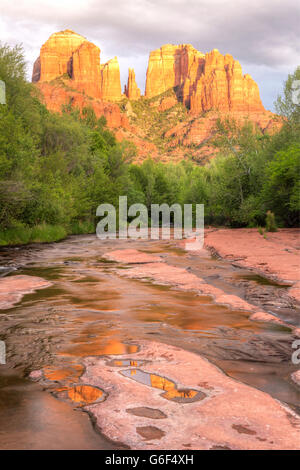 Cathedral Rock is reflected in puddles on the slickrock on Oak Creek in Red Rock Cross-Crescent Moon Park in Sedona, Arizona Stock Photo
