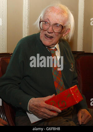 Former Labour Party leader Michael Foot unwraps a present at the Gay Hussar in Soho, London, at a party being held to mark his 90th birthday. Stock Photo