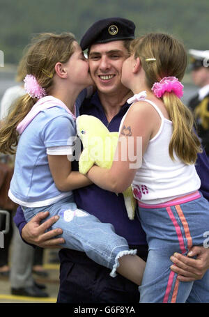 Trevellan Stevenson is greeted by his eight-year-old twins Natasha (left) and Alix as HMS Splendid returns from the Gulf, to HM Naval base Clyde, Faslane. * The 107 crew were deployed to the Gulf region in early January and fired Tomahawk Cruise missiles against ground targets in Iraq during the conflict. Stock Photo