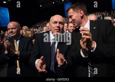 Cabinet ministers (from left to right) Foreign Secretary William Hague, Work and Pensions Secretary Iain Duncan Smith and Health Secretary Jeremy Hunt applaud Prime Minister David Cameron after he delivered his keynote speech on the final day of the Conservative Party Conference at Manchester Central in Manchester. Stock Photo