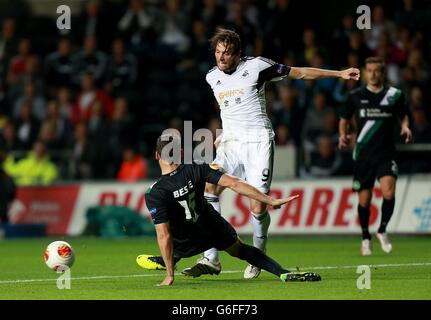 Soccer - UEFA Europa League - Group A - Swansea City v St Gallen - Liberty Stadium. Swansea City's Miguel Michu (right) is challenged by St Gallen's Stephane Besle Stock Photo