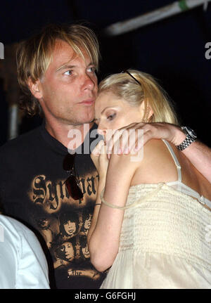 TV presenter Donna Air and boyfriend Damien Aspinall watch The Appleton's performing during the V2003 music festival in Chelmsford, Essex. Stock Photo