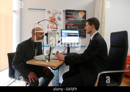 Rowling Scholar, Dr James Cameron(right) uses an OCT eye scanner in a clinical room in The Anne Rowling Regenerative Neurology Clinic at Edinburgh University after it was officially opened by the Princess Royal, in her capacity as Chancellor of the university. Stock Photo