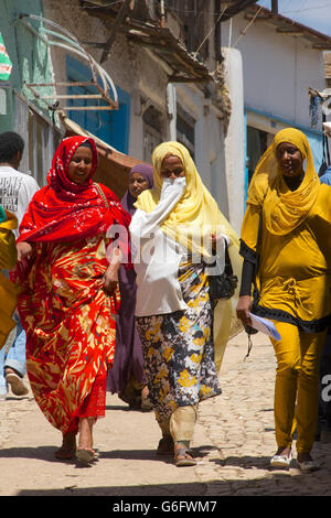Harari women walking in the street wearing colourful clothing. Harar, Ethiopia Stock Photo
