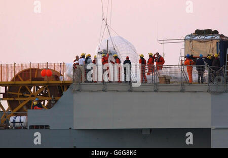 The launch team examine the deflated QinetiQ1 on board the prototype trimaran warship Triton off the coast of Cornwall Wednesday September 3, 2003, after the cancellation of an attempt for a world altitude balloon record. The 1,270 ft tall balloon lost helium while being inflated. British balloonists Colin Prescot and Andy Elson had been set to travel 25 miles up into the edge of space. Stock Photo