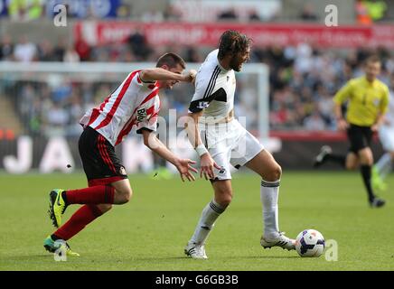 Swansea City's Miguel Michu (right) and Sunderland's Valentin Roberge (left) battle for the ball Stock Photo