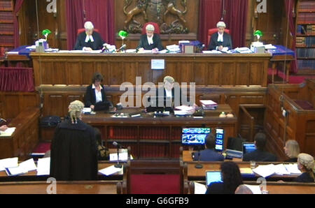 A still taken from the video feed of the first filming of a court case from the Court of Appeal in London, (top left to right) Judge Anthony Morris QC, Lord Justice Pitchford and Mr Justice Globe in the case of Kevin Hugh Fisher who is applying for leave to appeal against sentence of seven years for counterfeiting offences. Stock Photo