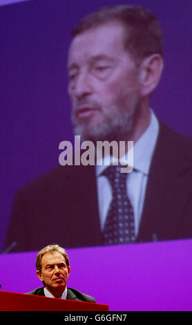 Prime Minister Tony Blair listens to the Home Secretary David Blunkett delivering his keynote speech to the Labour Party Conference in Bournemouth. Blunkett signalled further action to curb gun crime if Labour gains a third term of office. Mr Blunkett told Labour's conference: Two terms in office isn't enough to prepare Britain for the century ahead. In his keynote speech, he indicated the challenge of gun culture would be tackled head on if Labour won a third term in power. Stock Photo