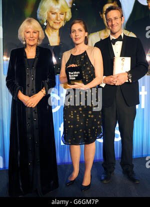 Eleanor Catton (centre) winner of the Man Booker Prize for her book The Luminaries, poses with The Duchess of Cornwall (left) and Robert Macfarlane, Chair of judges (right) after winning the award at the Guildhall, London. Stock Photo