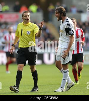 Swansea City's Miguel Michu (right) screams in anger at referee Craig Pawson (left) after he is fouled by Sunderland's Valentin Roberge Stock Photo