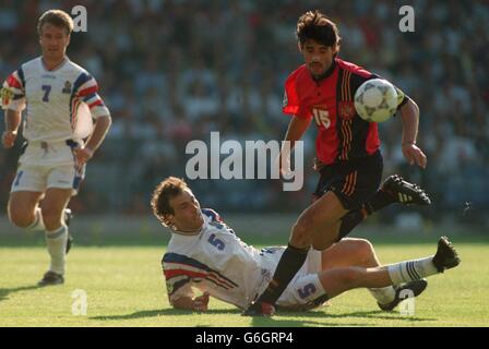 Soccer - Euro 96 - France v Spain. France's Laurent Blanc tackles Spain's Jose Caminero Stock Photo