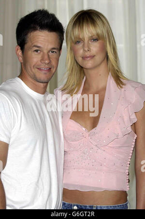 Actors Mark Wahlberg and Charlize Theron pose for photographers during a photocall to promote their new film 'The Italian Job' at Claridges in central London ahead of the films premiere in Leicester Square. Stock Photo