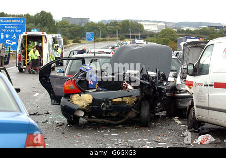 A car stands ruined after a crash involving 12 vehicles on the northbound carriageway of the M5 motorway near Bristol. Up to a dozen people were injured in the accident, which happened between junctions 20 and 19 of the motorway shortly after 1pm. The cause of the crash was not yet known, but a police spokesman said there were reports of a heavy downpour at around the time of the incident. Stock Photo