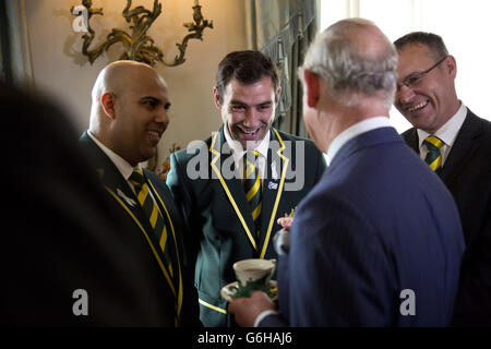 The Prince of Wales, speaks with (from left to right) Australia's national rugby league team team manager Gareth Holmes, captain Cameron Smith and Andrew Hill from the Australian Rugby League Commission, during a reception for the Rugby League World Cup at Clarence House in London. Stock Photo