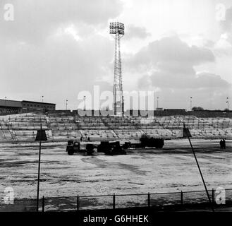 Road-burners, normally used to melt the tar macadam surface when relaying roads, quarter the playing pitch in an attempt to thaw the ice at Chelsea's ground at Stamford Bridge, London. * The home match fixed for tomorrow has been postponed, but the burners are being used in an attempt to get the pitch fit for next weeks FA Cup tie replay against Tranmere. Stock Photo