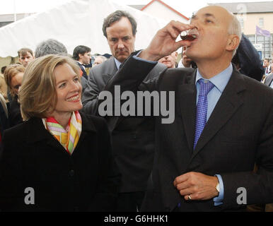 Conservative Party leader Iain Duncan Smith and his wife Betsy sample some gin as they tour a farmers' market in Blackpool. Earlier today, Mr Duncan Smith brushed aside suggestions that the party's 'men in grey suits' were set to call time on his leadership. Amid claims that up to 15 Tory backbenchers were calling for a vote of no confidence in his leadership, Mr Duncan Smith insisted that his focus was on ending Tony Blair's premiership. With the Conservative annual conference in Blackpool entering its second day, focusing upon dissent, Europe and taxation, Mr Duncan Smith insisted he would Stock Photo