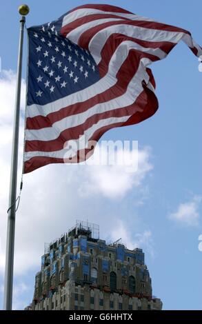 The Star Spangled banner flys in front of a view of the top of one of New Yorks elaborate Art Nouveau-inspired buildings Stock Photo