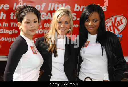 Pop band the Sugababes, from left to right; Mutya Buena, Heidi Range and Keisha Buchanan during the launch of a 30-foot high poster, as part of a new campaign for new Kit Kat Cubes in Covent Garden, London. Stock Photo