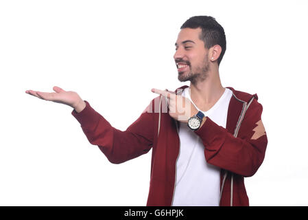 Attractive young latin man holding something on the palm. Isolated white background. Stock Photo