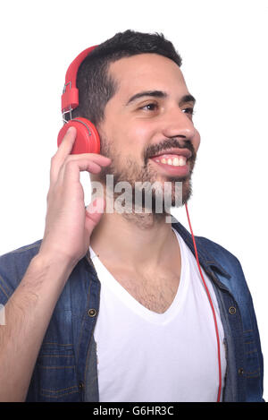 Portrait of young handsome man listening to music. Isolated white background. Stock Photo
