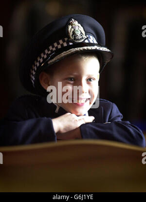 Six-year-old Greig Masson, who was hailed a hero last winter after alerting emergency services and comforting his pregnant mother after her foot was trapped and crushed under a car, recieved an award for his bravery. The award was presented to him by First Minister Jack McConnell during a ceremony held at the Great Hall, Edinburgh Castle. Stock Photo