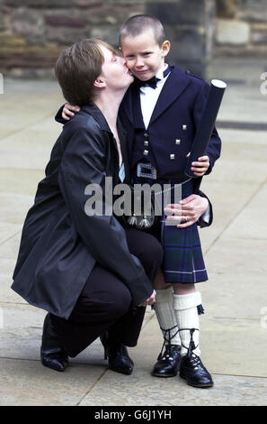 Six-year-old Greig Masson, receives a kiss from his proud mother Catriona, after the young boy was hailed a hero last winter after alerting emergency services and comforting his pregnant mother after her foot was trapped and crushed under a car. Greig received an award for his bravery presented to him by First Minister Jack McConnell during a ceremony held at the Great Hall, Edinburgh Castle. Stock Photo