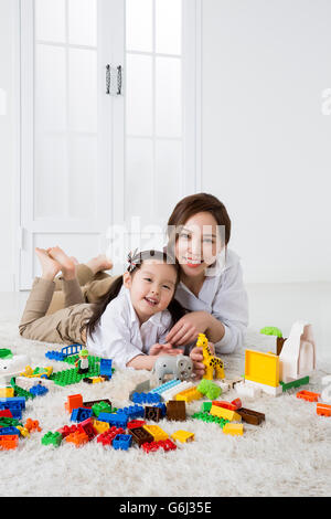 Asian Mother and Daughter Playing with Building Blocks at Home Stock Photo