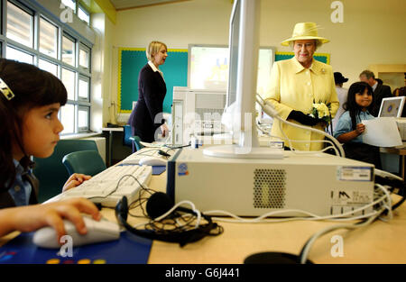 Britain's Queen Elizabeth II watches pupils using computers in the computer room at Keys Meadow Primary school, a new primary school in Enfield Lock. * During the visit to the London Borough of Enfield, the Queen and the Duke of Edinburgh unveiled a plaque at the Town Market commemorating the area s lengthy trading links. Enfield was granted its first market charter 700 years ago in 1303, and in 1632 the parish authorities created a central Market Place. The royal couple took part in a walkabout and met local residents before opening a new credit union in the shopping arcade. Stock Photo