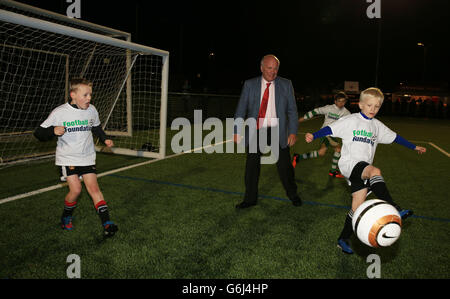 Football Association Chairman Greg Dyke watches children playing on the new all weather pitches during the opening of the new football centre at the Gloucestershire FA HQ at Oaklands Park in Almondsbury. Stock Photo