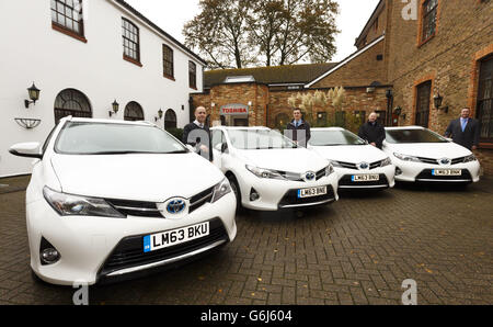 Staff at Toshiba in Chertsey, Surrey with some of their new fleet of Toyota Auris hybrid estate cars. PRESS ASSOCIATION Photo. Picture date: Monday November 11, 2013. Left to right: The users of the vehicles. Martin Stephenson, Tec Support, Stuart Davison, Sales Support, Steve Coles, Field Service Engineer and Andy Adderley, Field Service Manager. Photo credit should read: Chris Ison/PA Wire. Stock Photo