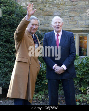 The Prince of Wales (left) meets Sir Roger Bannister outside some renovated farm buildings in which Sir Roger's descendants used to live, part of the Pendle Heritage Centre in the village of Barrowford, Lancashire. Prince Charles had earlier visited a regeneration project at Lomshaye Bridge Mill, in Nelson. Stock Photo
