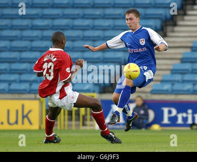 Millwall's Peter Sweeney (right) and Nottingham Forest's Wes Morgan in action during their Nationwide Division One match at Millwall's The Den ground in London NO UNOFFICIAL CLUB WEBSITE USE. Stock Photo