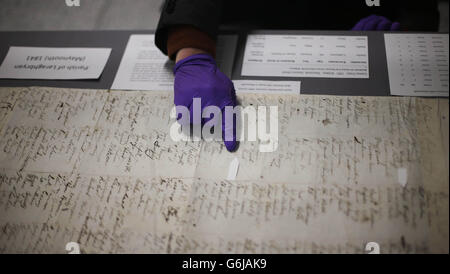 Conservator Paul Hoary points out names as the Morpeth Roll goes on display to the general public today at NUI Maynooth in Co Kildare. Stock Photo