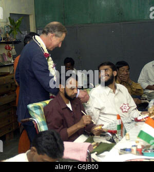 Prince Charles shakes hands with a man at the Cheshire Homes for disabled people during his visit of Mumbai, India. Stock Photo