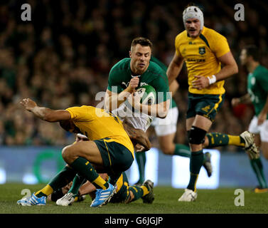 Ireland's Tommy Bowe (centre) tussles with Australia's Will Genia during the Guinness Series match at the Aviva Stadium, Dublin, Ireland. Stock Photo