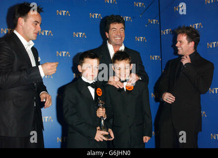 Anthony McPartlin (left) and Declan Donnelly (right) with Simon Cowell and Little Ant 'n' Dec with their award for Most Popular Entertainment Programme during the annual National Television Awards at the Royal Albert Hall in central London. Stock Photo