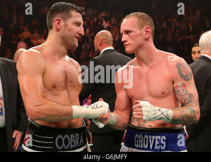 Carl Froch (left) and George Groves shake hands following the WBA and IBF Super Middleweight Title fight at the Phones 4u Arena, Manchester. Stock Photo